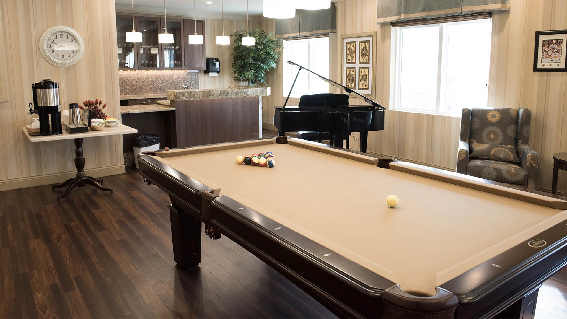 Game room with pool table, grand piano and coffee bar at MacTaggart Place retirement home